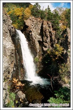 a waterfall in the middle of some rocks