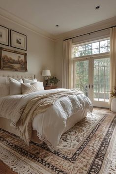 a large bed sitting in a bedroom on top of a rug next to a window