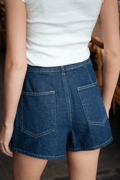 Get ready to turn heads with the Kenzi Asymmetrical Denim Skort! This quirky and playful skort features an asymmetrical design and a high waisted fit, perfect for adding a unique touch to your wardrobe. With a zipper and button closure, as well as side pockets, this skort combines functionality with style. Made with denim, it's versatile and effortlessly cool! General Info: 90% Cotton, 10% Polyester Dry Clean Asymmetrical High Waisted Zipper and Button Closure Side Pockets Denim Model Info: Heig Chic Denim Bottoms With Built-in Shorts, Fitted Recycled Denim Bottoms For Summer, Chic High-waist Rigid Denim Bottoms, Chic High Waist Rigid Denim Bottoms, High Waist Recycled Denim Bottoms With Belt Loops, Summer Recycled Denim Bottoms With Belt Loops, Chic Rigid Denim Bottoms With Pockets, Chic Denim Blue Cotton Jean Shorts, Chic Denim Blue Jean Shorts