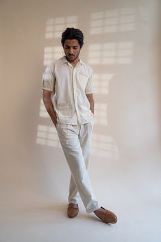 This Dawning Pleated Pants comes in a calm and soothing color. This 30s cotton pant is undyed and unbleached. Flattering mid-waist design with a straight-fit silhouette. Practical touches include side pockets, button-down fly, and belt loops. The pockets and hem are highlighted with the stitches of Kantha, a form of Indian hand embroidery to bring character to the garment. *This item is a final sale and not eligible for returns or exchanges. *This item can take up to 14 business days to ship as Indian Hand Embroidery, Slow Clothing, Soothing Colors, Pleated Pants, Sustainable Clothing, Cotton Pants, Fabric Care, Final Sale, Hand Embroidery