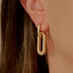 Details: Stainless steel. Water resistant. Modern Gold Hoop Earrings, Modern Gold Metal Hoop Earrings, Gold Hoop Earrings With Chain Detail, Gold Hoop Earrings With Gold Chain, Gold Hoop Earrings With Gold Chain For Everyday, Everyday Gold Hoop Earrings With Chain Detail, Hoops Gold, Steel Water, Water Resistant