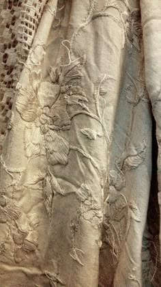 an old dress with lace and flowers on it