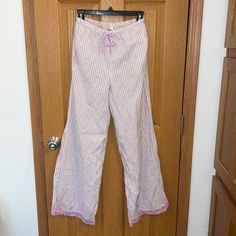 Victoria’s Secret White And Pink Striped Pajama Pants With Pink Lace Trim At The Bottom Of The Legs. Pants Feature Waist Pocket And Satin Waist Tie. Cotton Wide Leg Sleepwear For Lounging, Cotton Wide-leg Sleepwear For Lounging, Cotton Wide Leg Sleepwear For Pajama Party, Wide Leg Cotton Sleepwear, Pink Cotton Wide Leg Sleepwear, Wide Leg Sleepwear With Elastic Waistband For Sleepover, Victoria's Secret Pink Pants For Loungewear, Victoria's Secret Bottoms With Elastic Waistband For Loungewear, Spring Loungewear Pants By Victoria's Secret