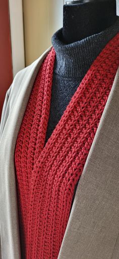 a close up of a mannequin wearing a red scarf