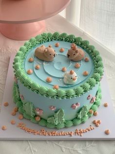 there is a cake that has bears in the water on it and bubbles coming out