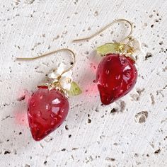 ♥ This exquisite earring features a stunning crystal texture that radiates beautiful light, adding a shimmering effect. The vibrant red strawberry design complements the delicate, translucent leaves, creating a captivating charm. The intricate details and glossy surface enhance the allure of these earrings. They are adored by garden enthusiasts and cherished by lovely young girls Length: 1.3 inches total (3.4cm) ♥ Care instructions: Substances like oil, nail polish, nail polish remover, chlorine Cute Red Handmade Jewelry, Cute Red Earrings With Fruit Design, Sweet Strawberry Print Jewelry As Gift, Cute Berry Colored Jewelry With Fruit Design, Cute Red Dangle Jewelry, Cute Berry-colored Jewelry With Fruit Design, Sweet Red Earrings For Gift, Cute Handmade Red Earrings, Cute Berry-colored Fruit Design Jewelry