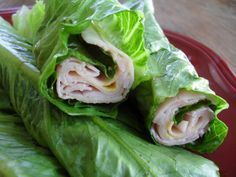 some lettuce wrapped in meat and sitting on top of a red plate,