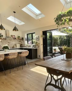 an open kitchen and dining room with skylights