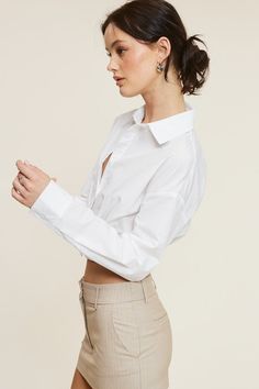 This White Giselle Shirt is the perfect addition to your wardrobe. With a cinched waist and overlap stitching details, it creates a lengthened torso effect for a unique and flattering look. The perfect cropped fit makes it a great standalone top. Elevate your style with this one-of-a-kind button-up. Fabric & fit: 80% nylon 20% cotton Model is wearing size Small. Stitching Details, White Button Up, How To Look Classy, Cinched Waist, Handbag Accessories, Dressing Up, Elevate Your Style, Button Up, Color White