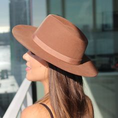 Teak brown unisex fedora hat in the Rancher style look. Sambboho's Blake hat has a hard brim and indented crown. This design has a vintage inspired silhouette with a soft grosgrain ribbon. It will provide high UV protection rated at 50+ UPF. This designer hat is very high end, handmade by our artisans with 100% Brazilian wool. This hat is unisex. You will be amazed by the quality. The timelessness chic and sophistication exuded by this hat make it a lifetime wardrobe investment you’ll never regr Adjustable Brown Boater Hat With Flat Crown, Classic Brown Fedora Hat, Brown Curved Brim Hat Bands For Kentucky Derby, Brown Curved Brim Fedora For Kentucky Derby, Western Brown Boater Hat With Flat Crown, Fitted Brown Panama Hat With Flat Crown, Brown Curved Brim Top Hat For Kentucky Derby, Brown Flat Crown Felt Hat For Summer, Brown Felt Hat With Flat Crown For Summer