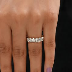 a woman's hand with a diamond ring on it