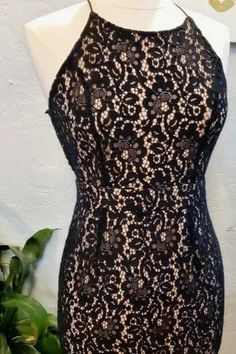 Classy, Sexy, and Flirty... You will turn heads in this backless, black-lace dress! Pair it with a great pair of heels and a red lip, and let the night take you where it wants!Cream colored midi dress featuring a delicate black lace detailing. Material: 65% Cotton; 35% Nylon Fully lined: 100% polyester Dry clean only. Fits true to size. Small: 1-4 Medium: 5-8 Large: 9-12 Bodycon Lace Dress For Night Out, Night Out Bodycon Lace Dress, Fitted Lace Bodice Dress For Date Night, Fitted Lace Dress With Lace Trim For Night Out, Party Lace Dress With Scalloped Lace And Stretch, Scalloped Lace Stretch Dress For Party, Stretch Scalloped Lace Dress For Party, Fitted Sleeveless Lace Dress With Lace-up Back, Fitted Flirty Lace Dress For Date Night