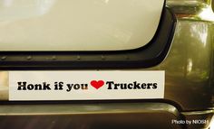 a sticker that says honk if you love trucks on the back of a car