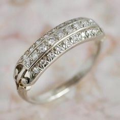 a white gold ring with three rows of diamonds