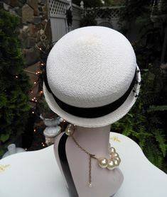 "LOVELY Classy Vtg 1940's Ladies White & Black Velvet Ribbon Woven Veiled Bumper Hat sz 21\" Diameter This is such a fun vintage Bumper hat from the 1940's. It's in just impeccable condition with no flaws I could note what so ever. The hat is a bright white woven fabric which feel synthetic to me. It has a short little brim which tilts up slightly at the sides with a gorgeous black veil attached to the front of the hat. There's a beautiful black velvet ribbon round the crown of the hat with Retro Adjustable Brimmed Boater Hat, Adjustable Brimmed Retro Boater Hat, Classic Adjustable Cloche Mini Hat, Retro Fitted Brimmed Mini Hats, Retro Adjustable Cloche Hat, Adjustable Mini Hat With Curved Brim For Vintage Events, Retro Adjustable Mini Hat With Flat Brim, Retro Adjustable Cloche Hat With Curved Brim, Vintage Mini Hats With Fitted Short Brim