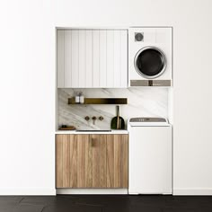 a white washer sitting next to a dryer on top of a wooden cabinet