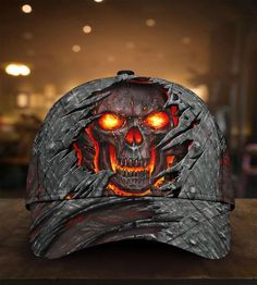 a baseball cap with an image of a demonic skull on it's front and sides