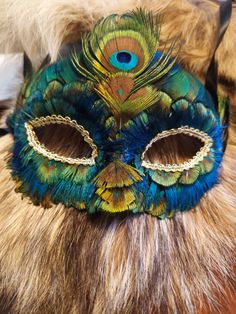 This gorgeous peacock feather mask is one of a kind! Perfect for Mardi Gras, cosplays, or masquerade ball! Handmade Masquerade Mask For Mardi Gras Carnival, Handmade Masquerade Mask For Mardi Gras, Handmade Masquerade Mask For Mardi Gras Costume Party, Carnival Feather Eye Mask, Feathered Masquerade Mask For Mardi Gras, Feathered Eye Mask For Carnival, Feathered Eye Mask For Masquerade Costume, Feathered Eye Mask For Costume, Feathered Masks For Mardi Gras Masquerade