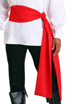 a man dressed up in a pirate costume with red sash and boots, holding his hand on his hip