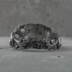 Ruins ring Sterling silverProcessing Type: volcanic oxidation+polishingTop:mmBack:mmWeight: (Depends on size)DESCRIPTION: Born from the artist's contemplation among ruins and giant trees, this unique ring embodies the monumental beauty of a bygone era. Every detail reflects the charming imperfection of the ancient sandstone buildings, giving a glimpse of the enduring charm of Cambodian heritage. All products are oxidized with volcanic sulfur that we collected while traveling in Indonesia, which Silver Brutalist Hand-cast Rings, Brutalist Silver Hand Cast Rings, Brutalist Oxidized Open Ring, Brutalist Open Ring With Oxidized Finish, Brutalist Oxidized Open Ring Jewelry, Brutalist Silver Engraved Rings, Unique Oxidized Wide Band Rings, Brutalist Sterling Silver Rings With Oxidized Finish, Unique Oxidized Open Engraved Ring