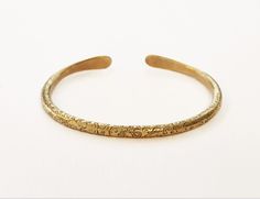 One Gold cuff  bracelet ,that stands out with it's special design.. one of a series of special  Bangles ( see them in my shop) that can be worn alone or a few together-as stackable cuffs.  A Unisex brass bangle bracelet, Boho cuff bracelet, This  beautiful  delicate piece of ethnic jewelry, Will give a special golden look to anything you were.  A special hand made present from Jerusalem   FEATURES: One cuff  bracelet Made of Brass Hammered and ornamented by hand, in an Ethnic style Shape: oval  Weight : 18.5 gr. Diameter : see in photos  Packaged carefully in a charming gift box. With a special small  polishing cloth for silver and brass jewelry. Delivery: Takes 7-28 Business days depending on your location. To see other BRACELETS with another design:     www.etsy.com/il-en/listing/1543138 Adjustable Bronze Bracelet For Wedding, Adjustable Bronze Bracelets For Wedding, Bohemian Antique Gold Brass Bracelets, Etched Brass Bracelet Jewelry, Etched Brass Bracelet, Handmade Adjustable Bangle For Ceremonial Occasions, Adjustable Intricate Cuff Bracelet For Ceremonial Use, Adjustable Intricate Design Cuff Bracelet For Ceremonial Occasions, Ceremonial Adjustable Cuff Bracelet With Intricate Design