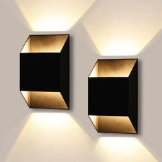 two black and gold square lights on the wall