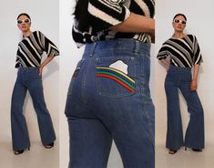 "Rare vintage '70s rainbow & cloud pocket jeans. 100% cotton denim. Mid rise with metal zipper fly. Front & back pockets with embroidered rainbow/cloud appliques on back pockets. Dark wash denim with flared, bell bottom hems. Super rare piece! DETAILS-----> Era: '70s Origin: California Fabric: 100% cotton denim MEASUREMENTS-----> Tag: n/a - no size marked - should fit a modern size small - s/m Waist: 14\" - snug 14.5\" Rise: 10\" Hips: 18.5\" Inseam: 32.5\" Total Length: 41.5\" Leg Front Pocket Jeans, Rainbow Jeans, Rainbow Patch, 70s Rainbow, Embroidered Rainbow, 70s Denim, Dark Wash Flare Jeans, Patch Jeans, 1970's Fashion