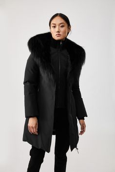 TRISH is a Powder Touch down coat for women with a Signature Collar with silver fox fur and a windproof shell. Water resistant, repellent, and breathable, it is expertly tailored to a fitted silhouette and features a distinctive asymmetrical zip closure for avant-garde styling. Storm cuffs and an inner ribbed bib add extra warmth in extreme weather. A bold style statement with protective comfort. Longline down coat 800 fill power Traceable duck down Arctic Rated: Down to -30°C Breathable and win Black Coat With Fur, Mackage Coat, Coat With Fur, Touch Down, True Winter, Black Down, Silver Fox, Duck Down, Down Coat