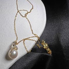 This captivating piece features lustrous natural freshwater pearl, the delicate charm of rhinestones and a whimsical flower design. It's perfect for women who adore the timeless elegance of pearls and the symbolic beauty of plants. 👌 M A T E R I A L * Natural Freshwater Pearl 9mm * 18K Gold Plated over brass * This product is hypoallergenic (nickel free) and tarnish resistant 📏 S I Z E * 44cm in total 🔨 P R O C E S S I N G ∙ T I M E All of our items are handmade with love and we start to prep Exquisite Gold Pearl Necklaces, Elegant Pendant Necklace For Mother's Day, Elegant White Gold Pearl Necklace For Jewelry Making, Elegant Pearl Jewelry With Pearl Pendant, Elegant Pearl Necklaces As Gift, Elegant Pearl Necklaces For Gifts, Pearl Clavicle Chain Necklace As Gift, Pearl Embellished Cubic Zirconia Jewelry As Gift, Exquisite Pearl Charm Jewelry As A Gift