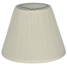 a white lamp shade with a silver metal handle on the top and bottom of it