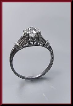 an antique style diamond engagement ring with filigrees