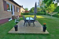 a table and chairs sitting on top of a wooden deck