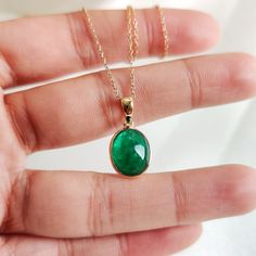 This stunning pendant is set in 14k Solid Yellow Gold with Natural Emerald with utmost precision. It is an unique gemstone pendant for nearly every occasion and is completely hassle-free jewelry. ITEM DETAILS: * Gem: Emerald * Gem Size: 9.5x11.5mm * Gem Shape: Oval * Gem Weight: 4.38 carats * Gold Purity: 14KT * Gold Weight: 0.52 gram * Total Weight of the Pendant: 1.40 gram The Gold purity is guaranteed and it comes with authentic 14KT gold hallmark. Since my items are handmade, they are absolutely nickel and lead free. CUSTOMIZATION: * Gemstone customization is available and it can be substituted with a gem of your choice. Kindly message me for the same. PACKAGING * The Pendant comes with layers of safe and secure wrapping along with Free handmade jewelry box with every purchase. ➡️Head Fine Jewelry Cabochon Gemstones For Gifts, Fine Jewelry Cabochon Gemstones As Gift, 14k Gold Gemstones With Bezel Setting For Gift, 14k Gold Emerald Necklace With Bezel Setting For Anniversary, Oval Pendant Jewelry With Bezel Setting As Gift, Yellow Gold Gemstones With Bezel Setting, Classic Emerald Necklace With Round Pendant, Oval Pendant Necklace With Bezel Setting For Gift, Oval Pendant Emerald Necklace As Gift