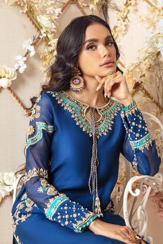 Over a canvas of silk net in stunning deep blue hue , featuring a beautiful floral embroidery in gold further enhanced with applique work, gold dabka, sequins, crystals, beads and pearls. This outfit is paired with stunning jacquard woven dupatta and embellished culottes, perfect for any celebratory occasion. Shirt & culotte Fabric: Silk Net Shirt Length: 45” Dupatta Fabric: Jacquard Chiffon Shirt & culotte Color: Deep Blue Dupatta Color: Deep Blue & Opal All outfits are fully lined Lining in sl Blue Embroidered Party Wear Dupatta, Blue Silk Dupatta With Dabka, Dabka Work Embroidery, Blue Embellished Dupatta For Eid, Luxury Embellished Blue Dupatta, Elegant Blue Embellished Dupatta, Fancy Work Outfits, Asian Wedding Dress Pakistani, Pakistani Party Wear Dresses