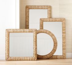 three wicker frames sitting on top of a wooden floor