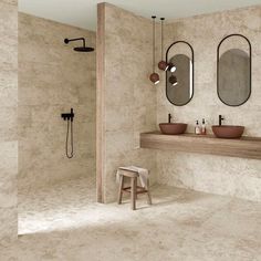 a bathroom with two sinks and mirrors on the wall, along with a stool in front of it