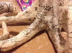 a close up of a fake animal with writing on it's body and feet