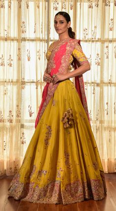 Editor's Note This set features a gorgeous greenish-yellow organza kalidar lehenga with tilla border, an organza blouse, and a red chiffon dupatta with jaal and tilla border. The intricate detailing of tilla work adds a touch of elegance to the ensemble. Fabric: Organza, chiffon Color: Yellow, red, green Components: Lehenga, blouse and dupatta Occasion: Haldi mehndi Disclaimer: Product color may slightly vary due to photographic lighting sources or your monitor setting. Care: Dry clean only Abou Yellow Anarkali Set With Dupatta For Transitional Season, Transitional Season Yellow Anarkali Set Traditional Drape, Transitional Yellow Raw Silk Anarkali Set, Yellow Chanderi Sets For Reception, Transitional Organza Lehenga With Cutdana, Yellow Chanderi Salwar Kameez For Reception, Yellow Tissue Silk Sets For Transitional Season, Yellow Chanderi Traditional Wear For Reception, Transitional Lehenga With Pallu In Organza