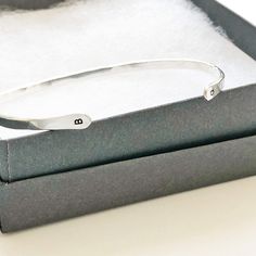 Our "Charlie" bangle with initials is understated, delicate and simple. Perfect for you or a gift for someone special. - Initials at each end of the bangle make it extra special. You can add a first and last initial. - We make these by hand so each one has its very own personality - One size fits most - A 6.5 inch bracelet with 1 inch opening that can be squeezed open or closed - Please message us at hello@sarahcornwelljewelry.com if you need a custom size. - all pieces are Sterling Silver or 14 Minimalist Monogram Bracelet For Everyday, Classic Personalized Initials Bracelet, Minimalist Engraved Name Bangle Bracelet, Classic Initials Bracelet, Perfect As Gift, Personalized Sterling Silver Initials Bracelet, Sterling Silver Initials Bracelet For Personalized Gift, Classic Adjustable Bracelet With Initials, Classic Adjustable Initials Bracelet, Sterling Silver Bracelets With Initials For Anniversary