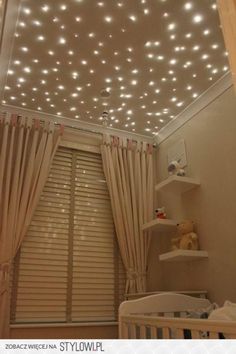 a baby's room is decorated with white lights