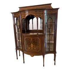 an antique wooden display cabinet with glass doors