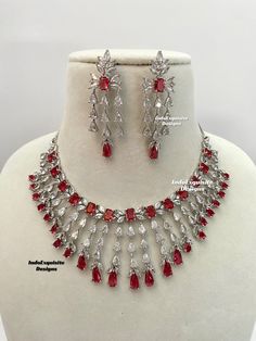 American Diamond Necklace Set / CZ Necklace/ Bollywood Jewelry/AD necklace/Reception/Wedding necklace/Silver red  All items are shipped from Brampton, Ontario, Canada. If you need your item by a certain day, please reach out to us for express delivery option before placing the order so that we can update the shipping for you. Standard shipping/delivery timeline Below are the delivery timeline estimates once the order is shipped. ---> USA delivery timeline * 3-6 business days to major urban cente Red Bollywood Jewelry Sets For Party, Traditional Red Necklaces For Anniversary, Red Cubic Zirconia Jewelry Sets For Festive Occasions, Red Hand-set Necklace For Party, Hand Set Red Necklace For Party, Red Hand Set Necklace For Party, Red Ruby Kundan Necklace For Wedding, Formal Bollywood Jewelry In Red, Red Bollywood Style Jewelry For Formal Occasions