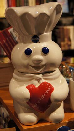 a ceramic bunny holding a heart on top of a table