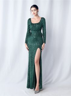 Nebula-like in its sparkle, this emerald green party dress is a celestial phenomenon. The sequins scattered across the fabric mimic the stars in the night sky, with a high slit that adds an element of the cosmic unknown. The squared neckline frames the face beautifully, and the long sleeves with feathered accents are reminiscent of the ethereal wings of a mystical creature. Mystical Creature, Sequined Fabric, Split Prom Dresses, Mermaid Sweetheart, Squared Neckline, Green Mermaid, Mermaid Sequin, Blue Party Dress, Sequin Prom Dress