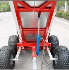 a red and white trailer with two large tires