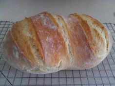 a loaf of bread sitting on top of a cooling rack