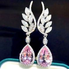 A delightfully unique pair of wedding earrings for the unconventional bride! The flawlessly faceted cubic zirconia stones capture the light in a dazzling array of sparkles, while the delicate drops add an extra touch of femininity. The earrings are rhodium plated for a bright finish which enhances the intricate detailing and conveys a modern take on classic elegance. Length: 1.8" (approx. 4.5cm); Width: 0.4" (approx. 1cm); Weight: 4g/earring. Available with Pink and Clear stones. To make your ch Cubic Zirconia Bridal Earrings, Bridal Wedding Earrings, Wedding Earrings Drop, Pink Jewelry, Trendy Earrings, Crystal Drop Earrings, Fashion Jewelry Earrings, Pink Diamond, Gold Fashion