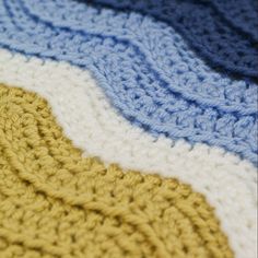 there is a crocheted blanket that looks like it has been made with yarn