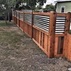 a wooden fence in front of a house