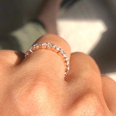 a woman's hand with a diamond ring on it